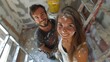 © Jay Koppelman - Smiling couple covered in paint during home renovation