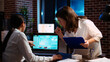 © DC Studio - Manager and company financial advisor analyzing statistical graphs, zoom in shot on laptop screen. Management executive and worker comparing business revenue numbers in brick wall office, camera A