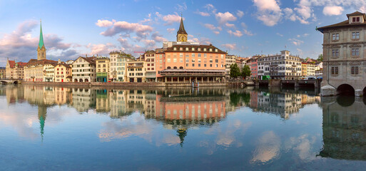 Wall Mural - Panoramic view of Zurich waterfront with reflections of Fraumunster and St Peters Church, Switzerland
