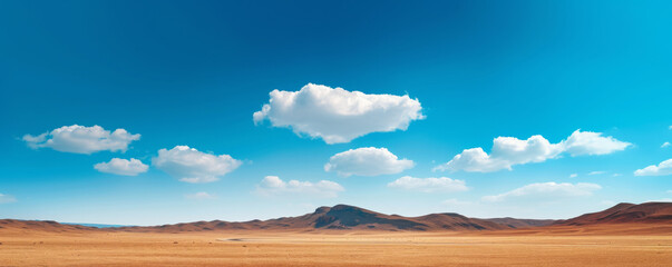 vast desert landscape with mountains under a bright blue sky and scattered clouds. nature and wilder
