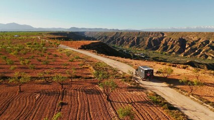 Wall Mural - All terrain camper van driving through the Gorafe desert in Andalusia, Spain