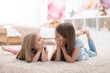 © New Africa - Cute little sisters on floor at home