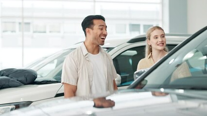 Canvas Print - Couple, car and talking or browsing in dealership, conversation and people for automobile shop or rental service. Vehicle, transport and discussion for features, investment and customer in showroom