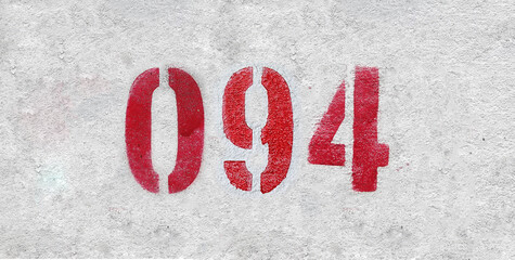 Red Number 094 on the white wall. Spray paint.