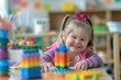 © Boraryn - Little girl with Down syndrome playing with toys in Montessori school. Social Inclusion, children with disabilities and special needs concept