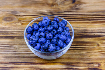 Wall Mural - Blueberry in glass bowl on a wooden table