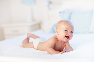 Wall Mural - Baby boy on white bed