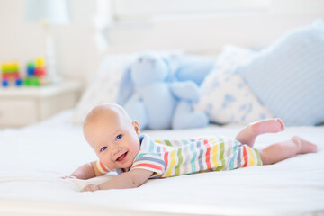 Wall Mural - Little baby on white bed