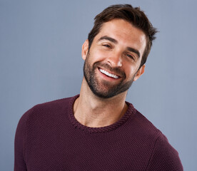Wall Mural - Studio, face and smile of man, fashion and confidence in mockup space, pride and cardigan in winter. Blue background, portrait and person in Miami, happy and comfortable in clothes, joy and jersey