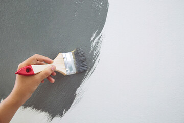 Wall Mural - Brush Painting, Worker painting on surface wall  Painting apartment, renovating with grey color  paint. Leave empty copy space white to write descriptive text beside.