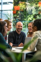 A diverse group of colleagues laughs and collaborates in an open office