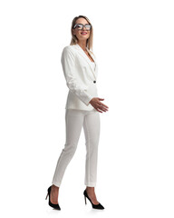 Wall Mural - young businesswoman in white suit stepping to side