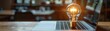 © ParinApril - Conceptual art of a bright light bulb on a modern laptop, emitting a burst of energy, representing ideas and digital innovation
