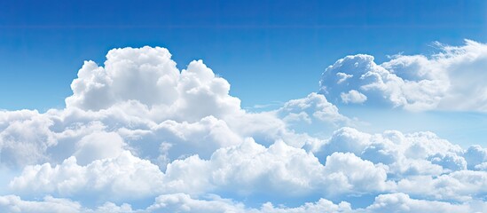 Wall Mural - Background with white clouds against a blue sky, providing copy space image.