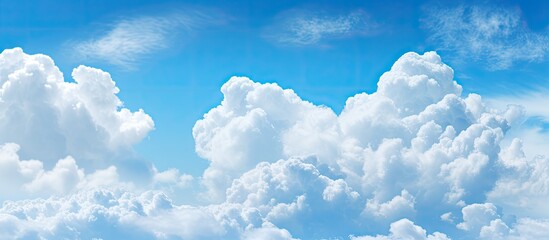 Aufkleber - The blue sky with fluffy white clouds provides a serene backdrop for the copy space image.