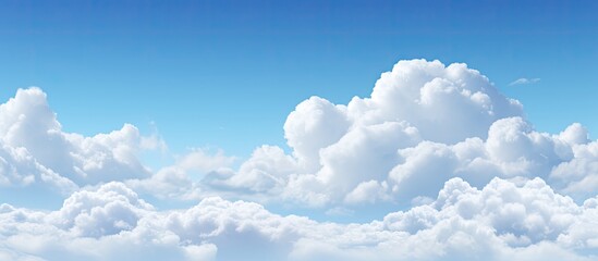 Aufkleber - Fluffy white clouds dotting the clear blue sky offer a serene view for a copy space image.