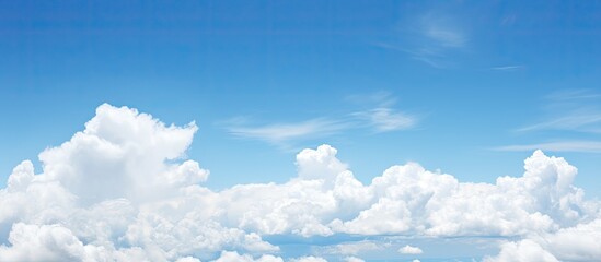 Aufkleber - Fluffy white clouds dotting the clear blue sky offer a serene view for a copy space image.