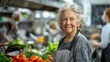 © MAY - An older adult, with a gray apron, attentively listening to a cooking instructor's advice on how to improve their culinary skills during a cooking workshop.