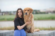 © shymar27 - A beautiful young dark-haired girl walks with a purebred retriever in nature.