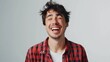© Ева Поликарпова - A smiling man wearing a bold red and black plaid shirt