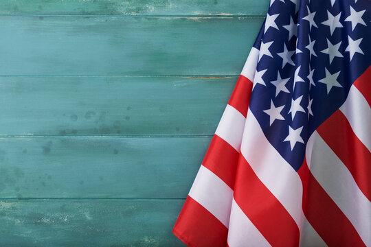 4th of July background. Empty wooden blue plank table with American USA flag. National Flag Day. Happy Labor, Independence or Presidents Day. American flag colors. Close up with place for text.