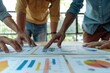 © Nognapas - Group of business people working together on new project with planning analytical report at meeting. Businesspeople meeting together pointing to graph assess business profits.