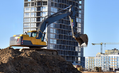 Sticker - Excavator during excavation at construction site.  Backhoe on Earthworks. Heavy Construction Equipment Machines in Action. Big Digger Digging the Foundation House. Soft focus