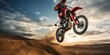 © PNG City - motorcycle stunt or car jump. A off road moto cross type motor bike, in mid air during a jump with a dirt trail. cnayon with blue sky