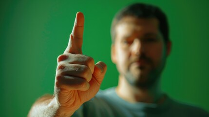 Wall Mural - A man is pointing at something with his finger. The image has a casual and relaxed mood, as the man is not in a formal setting