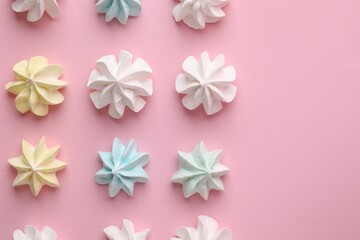 Wall Mural - Many tasty meringue cookies on pink background, flat lay. Space for text