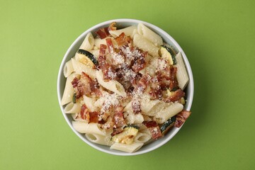 Poster - Tasty pasta with bacon and cheese on light green table, top view