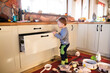 © Halfpoint - Little boy is taking kitchen utensils out of the drawers, making a mess in the kitchen.