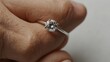 © TajHussain - : A minimalist engagement ring with a solid white background ai_generated