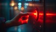 © owen - Close-Up of Hand Pressing Red Button in Modern Industrial Setting with Blurred Background Lights