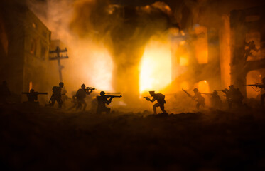 Wall Mural - Conceptual image of war between Democracy and dictatorship using toy soldiers. Battle in ruined city.