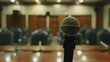 © Elchin Abilov - A close-up image showcases a microphone on a brown table in a meeting room.