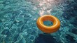 © olegganko - A Single Yellow Inflatable Ring Floating in a Blue Pool on a Sunny Day