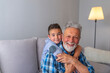 © Dragana Gordic - Shot of a happy senior man smiling looking at camera his grandson hugging him from behind copyspace relax family love people children retirement vitality lifestyle parenting childhood values weekend