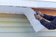 © ungvar - As part of remodeling process, house master repairs fascia trim that was damaged