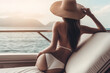 © Alienmonster Images - Captivating beachside elegance: A sun-kissed beauty in a bikini on a luxurious yacht with a stunning ocean view