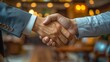 © chaisiri - A businessman shaking hands with a partner in a sleek, newly furnished office, symbolizing the successful launch and networking of a new business.