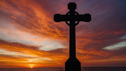 Wall Mural - Silhouetted Christian cross against a serene ocean sunset backdrop