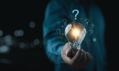 Aufkleber - Businessman holding glowing lightbulb and question mark with copy space for creative thinking idea and problem solving concept.