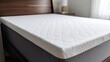 © Lubos Chlubny - White memory foam mattress topper on bed