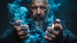 © Mikus - A man with tattoed facial features holds a cigarette between his hands, one hand steadying it while the other raises a lighter towards it He gazes intently into the camera lens