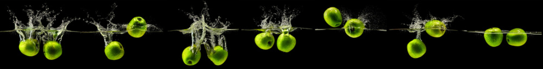 Wall Mural - Green apple falling in water on black background