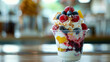 © CQSP - Frozen yogurt with a variety of colorful toppings in a stylish glass cup on a summer day