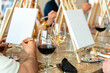 © Alfonso Soler - Sip and Paint Event. Group of friends painting and drinking wine