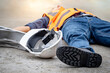 © Summer Paradive - Accident and injury on a construction site. Safety first concept. Male worker lying down unconscious on the floor with safety helmet after falling from ladder. Fainting from exhaustion or heat stroke