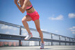 © Westend61 - Sportswoman sprinting on bridge under sky